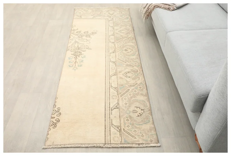 Full top view of the 2'4" x 6'4" cream and gray Anatolian runner rug on a white background.
