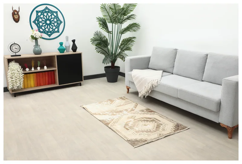 Full top view of the 3x5 beige and brown geometric vintage Anatolian rug on a white background.