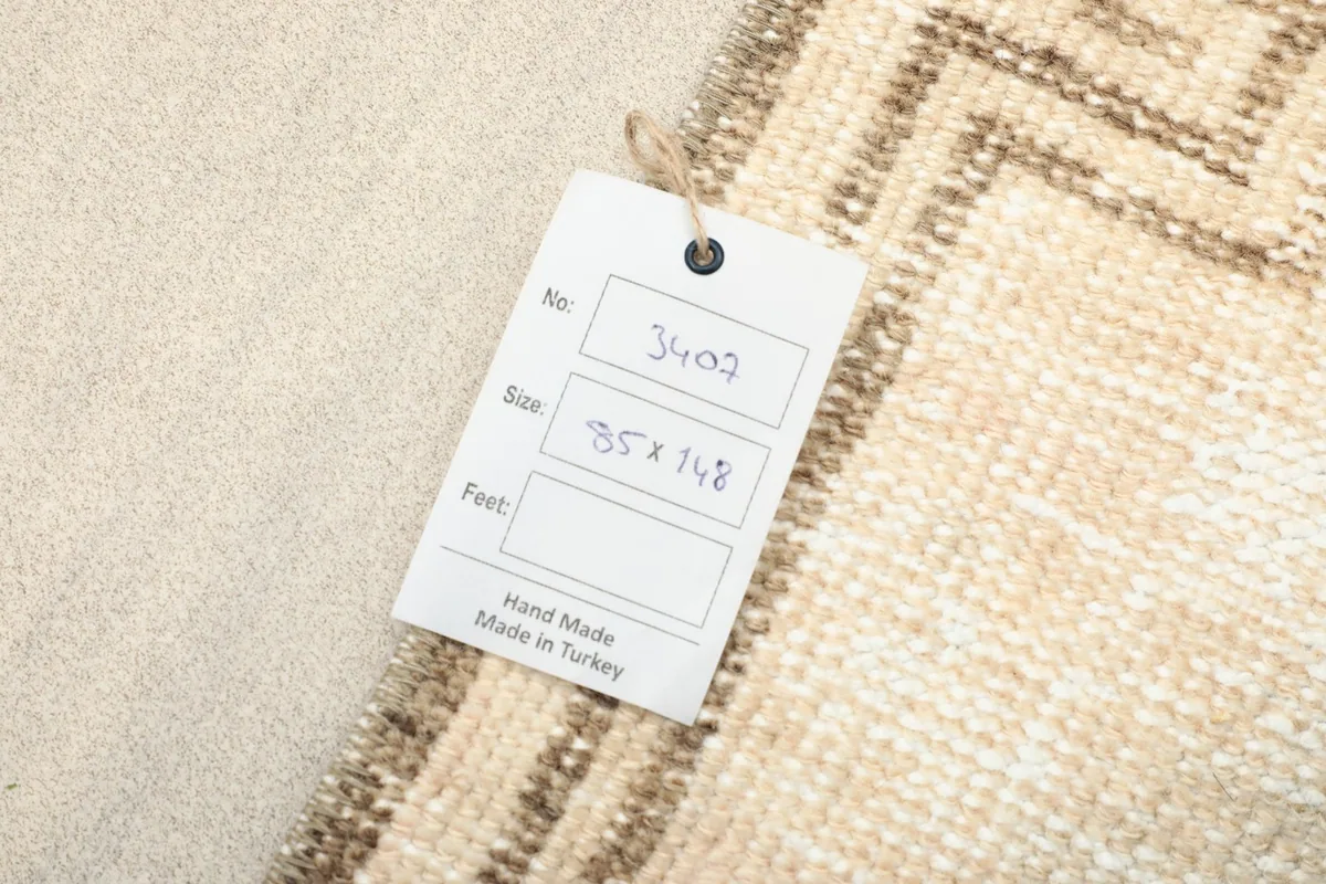 A tag on the rug showing details like item number and dimensions, confirming it is hand made in Turkey.