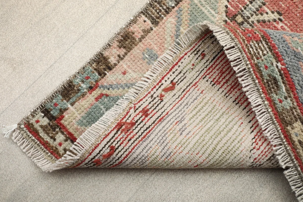 View of the back of the rug, revealing the cotton foundation and hand-knotted construction.