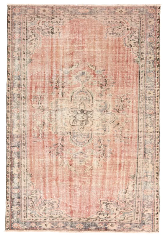 Full overhead view of the vintage rose and gray Anatolian rug on a white background