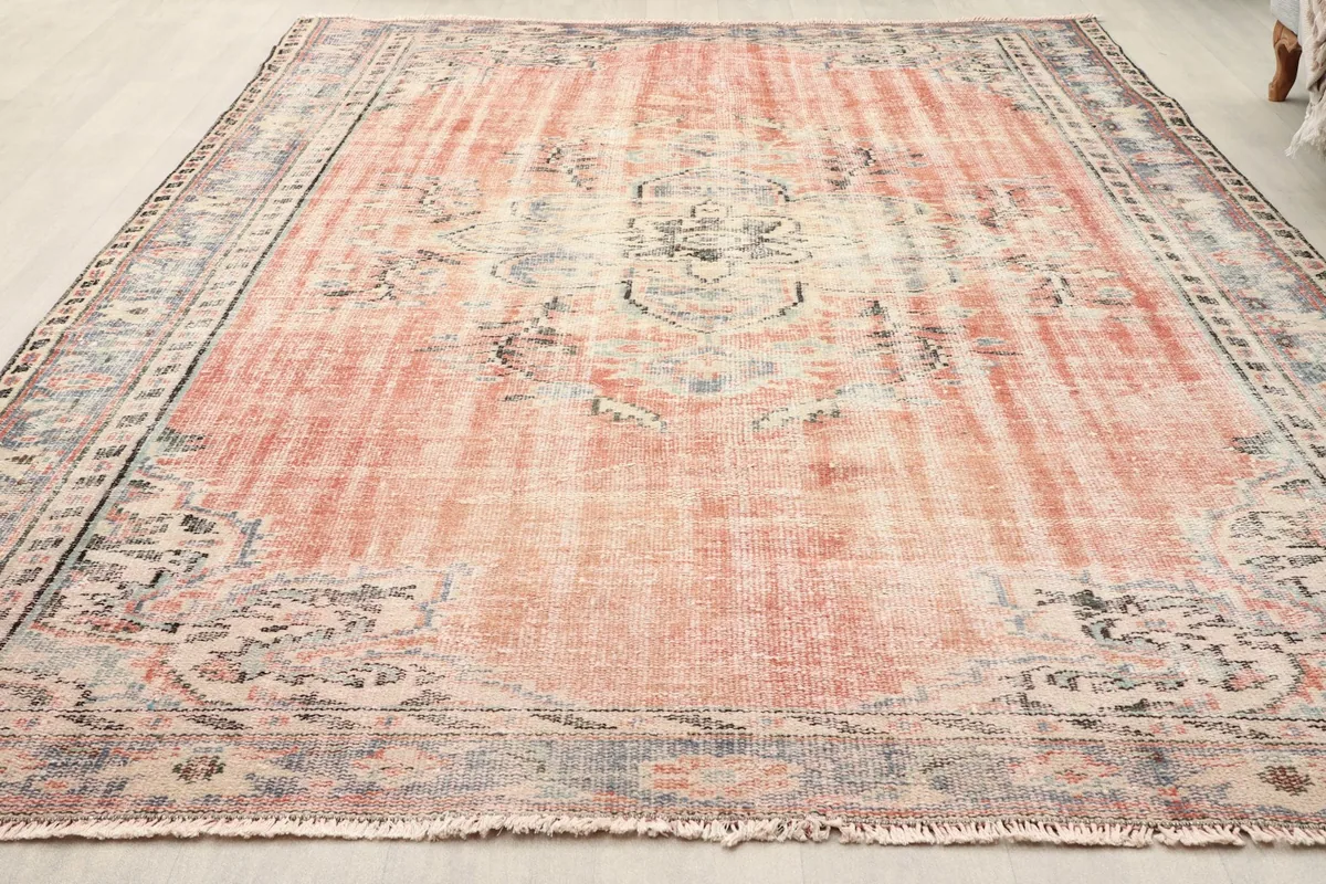 Angled view of the hand-knotted Anatolian rug, highlighting its rose field and gray border
