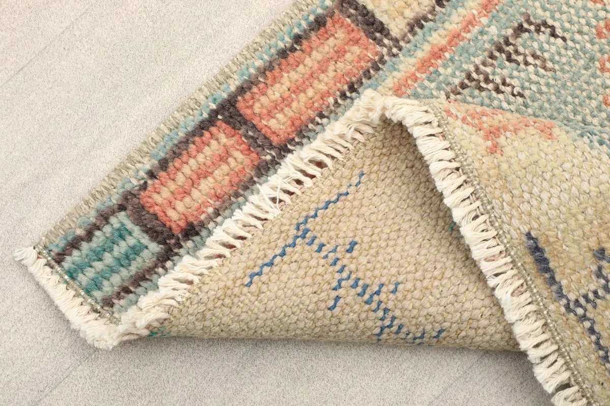 View of the back of the rug, revealing the cotton foundation and knotting