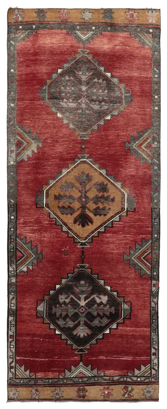 Full overhead view of the red tribal geometric Anatolian runner on a white background.