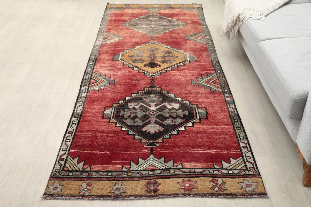 Full overhead view of the red runner displaying its tribal geometric patterns in a room setting.