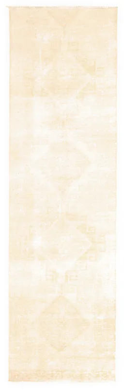 Full overhead view of the 2'11" x 10'2" ivory vintage Anatolian runner on a white background
