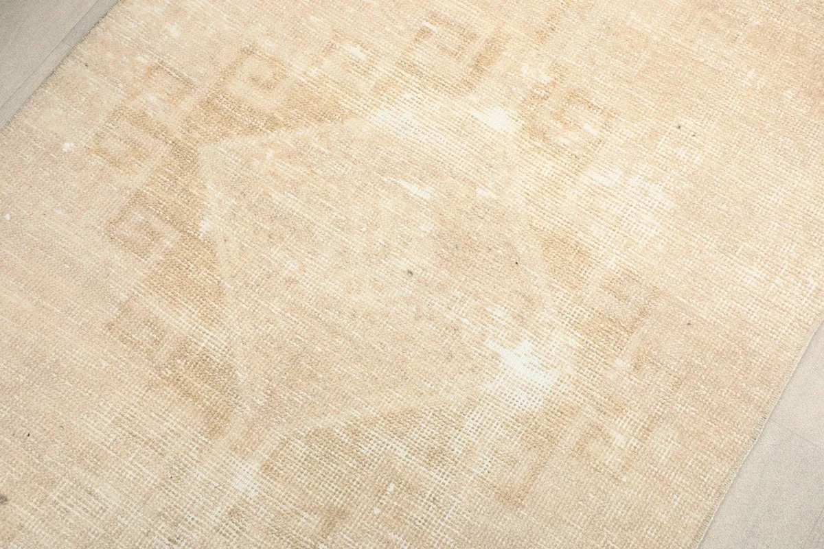 Overhead detail of the rug's central geometric motifs, showcasing the hand-knotted wool pile