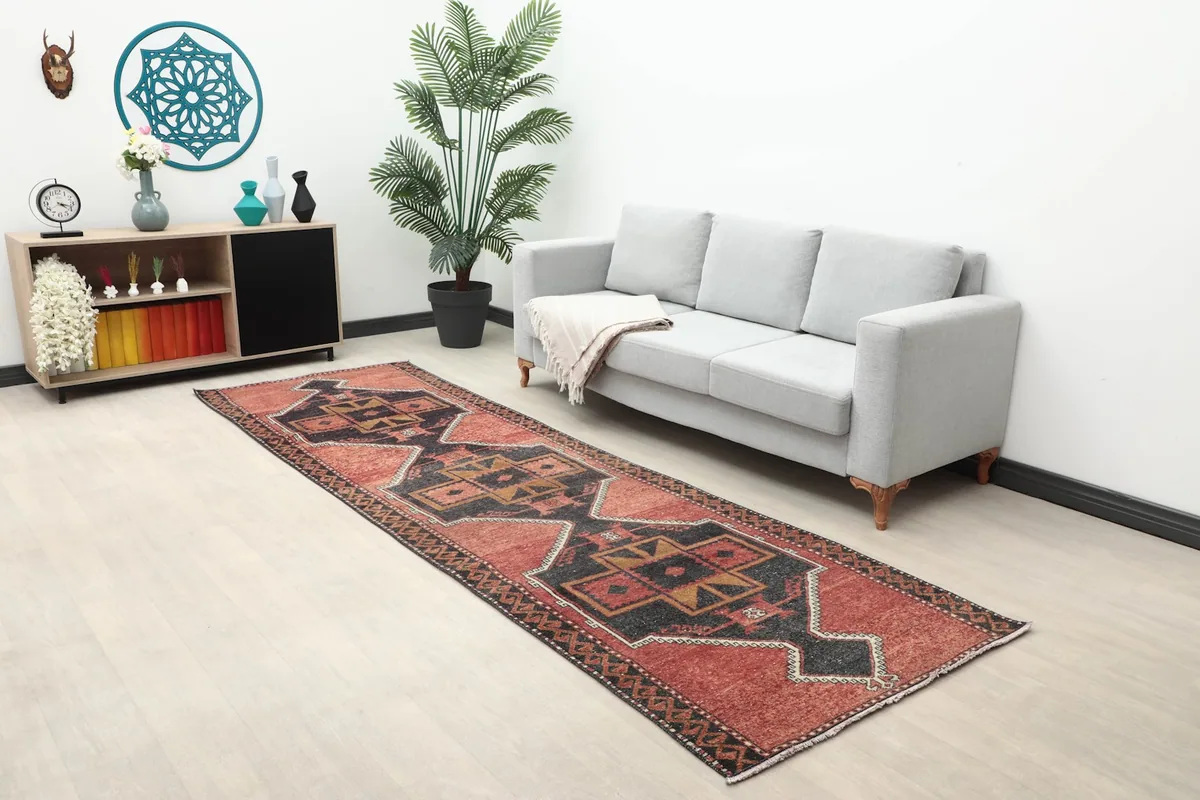 Full view of the red and black geometric runner rug in a modern living space