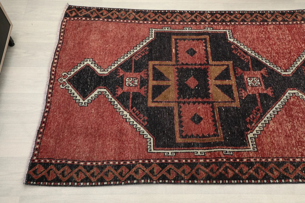 Overhead detail view of the rug's central geometric pattern and border