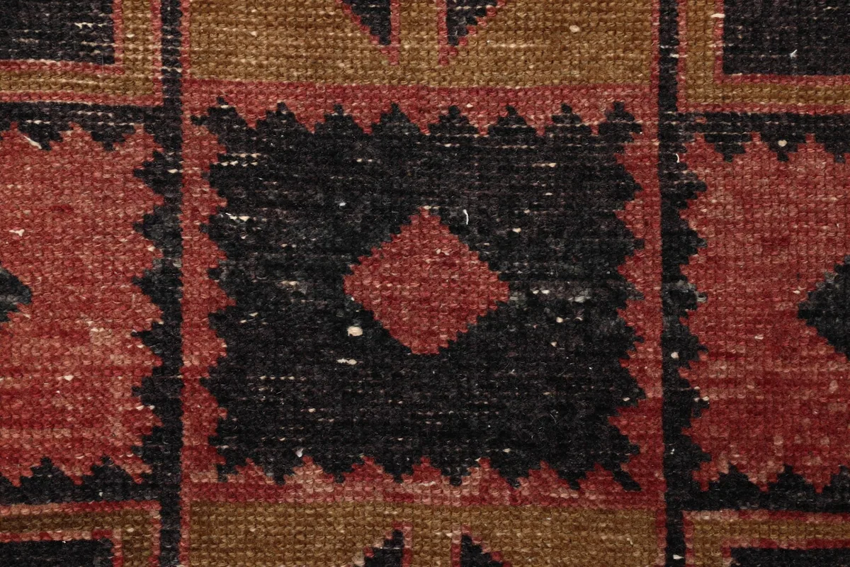 Close-up showing the low pile and hand-knotted texture of the wool rug