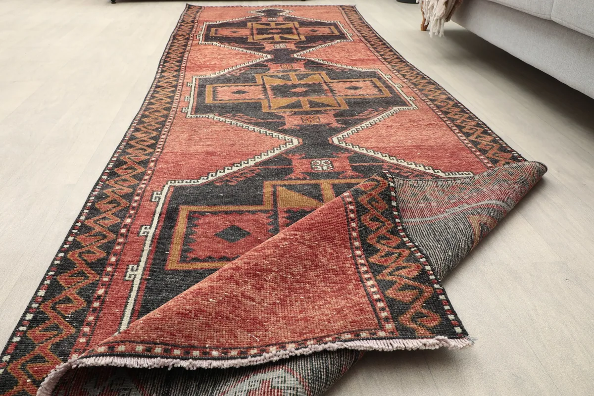 Partially rolled runner rug, highlighting its flexibility and construction