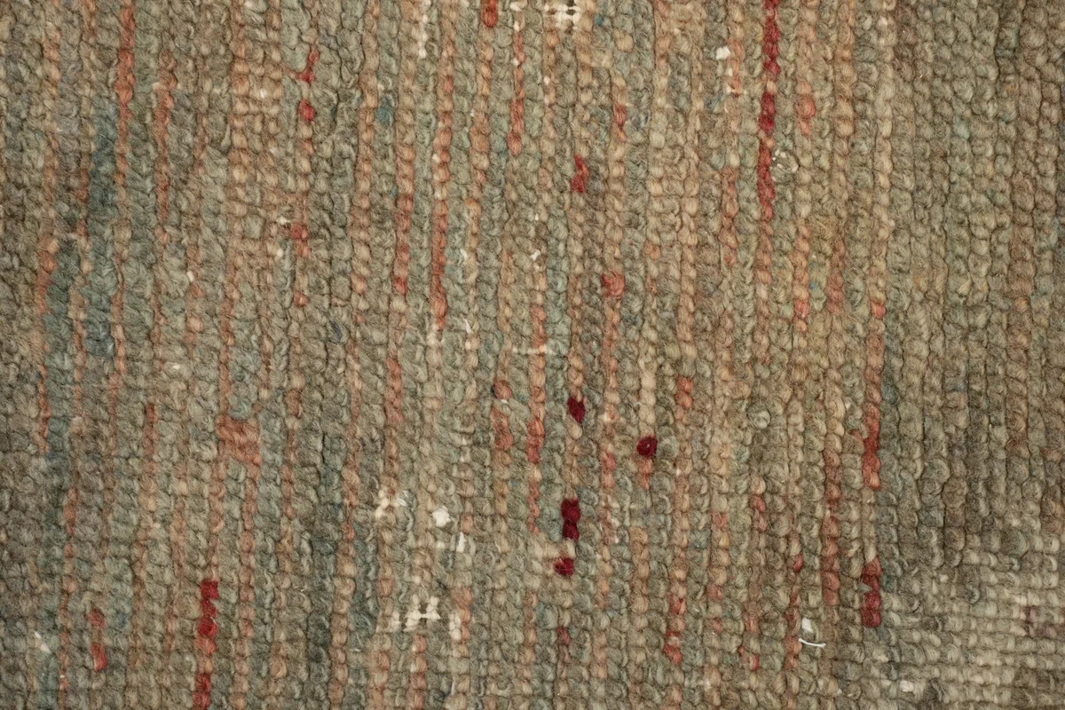 Very close view of the low wool pile, showing individual knots and threads