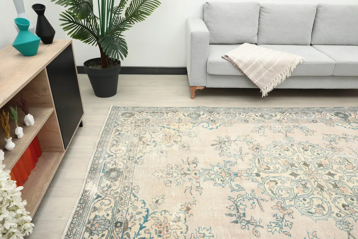 Angled view of the rug in a living room, showing its placement relative to furniture.
