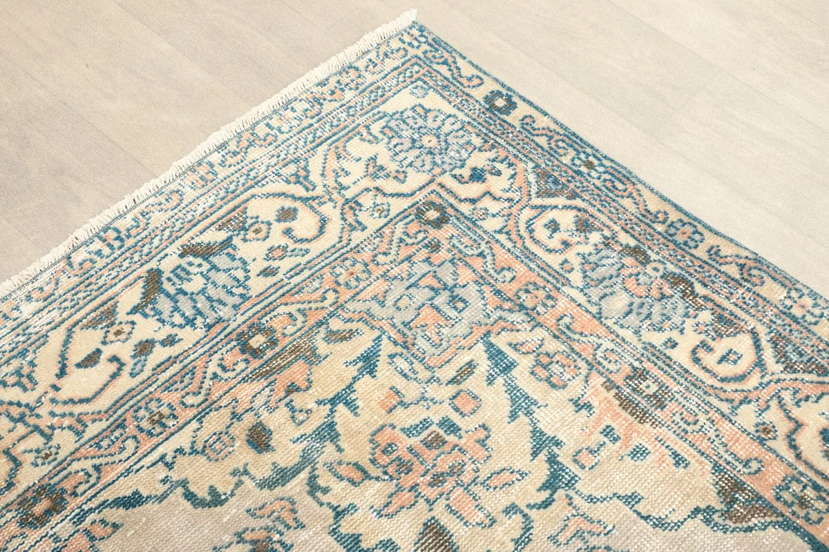Corner view of the rug showing the intricate border design and central field motifs.