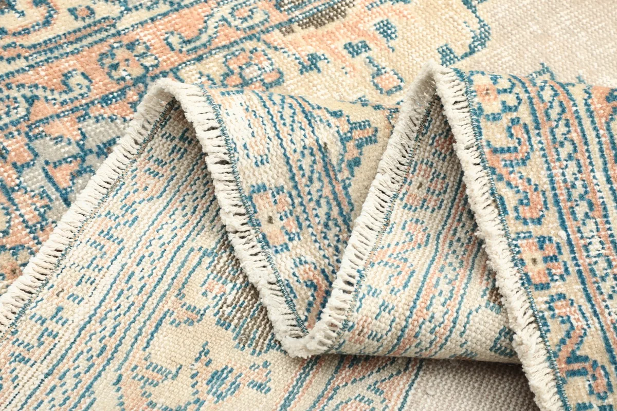 Folded section of the rug showing the density of the hand-knotted wool pile.