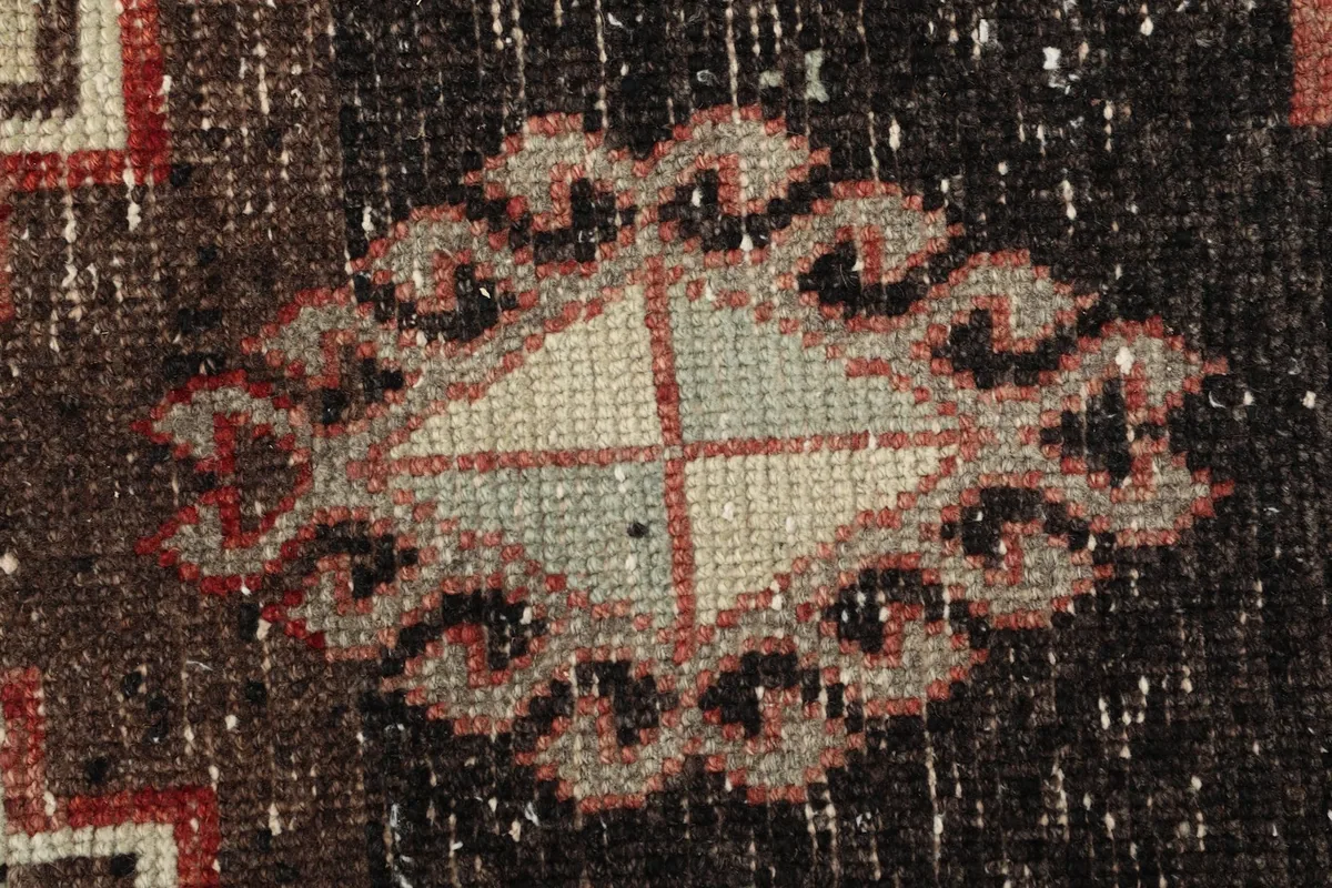 Extreme close-up of the hand-knotted wool pile, revealing texture and subtle color variations.