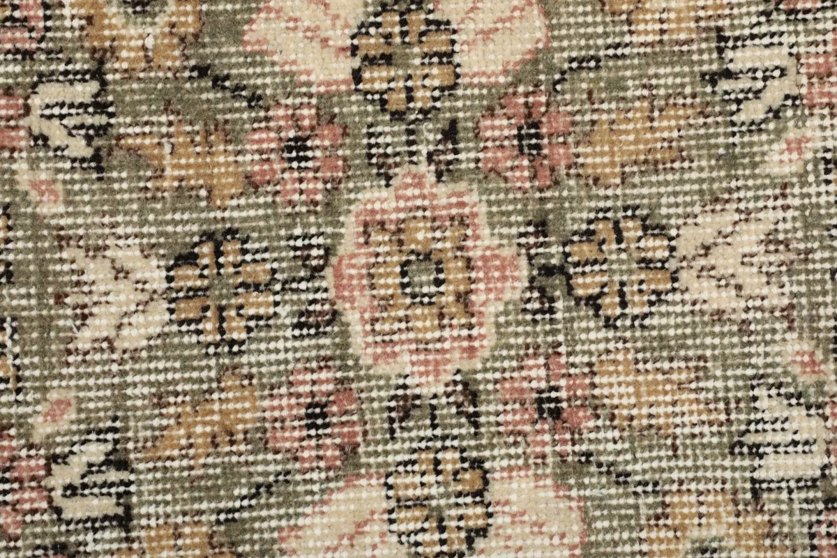 Macro view of the hand-knotted wool pile, showing texture and color variations