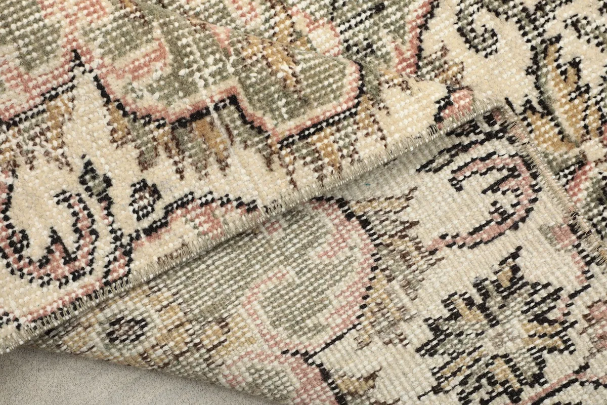 View of the rug's back, revealing the tight hand-knotted cotton foundation