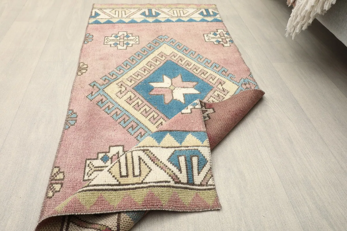 Partial overhead view with one corner folded back, showing the back of the rug.