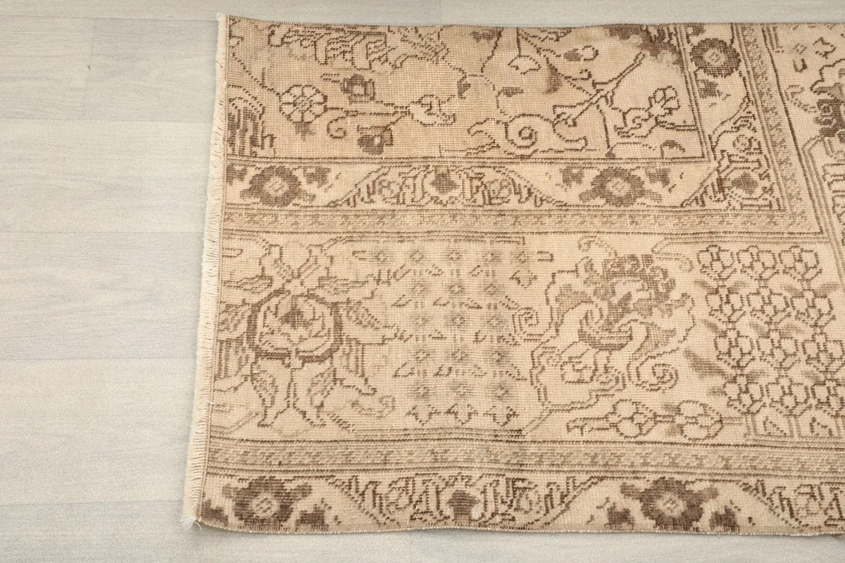 Detailed view of the rug's border and central motifs from one side