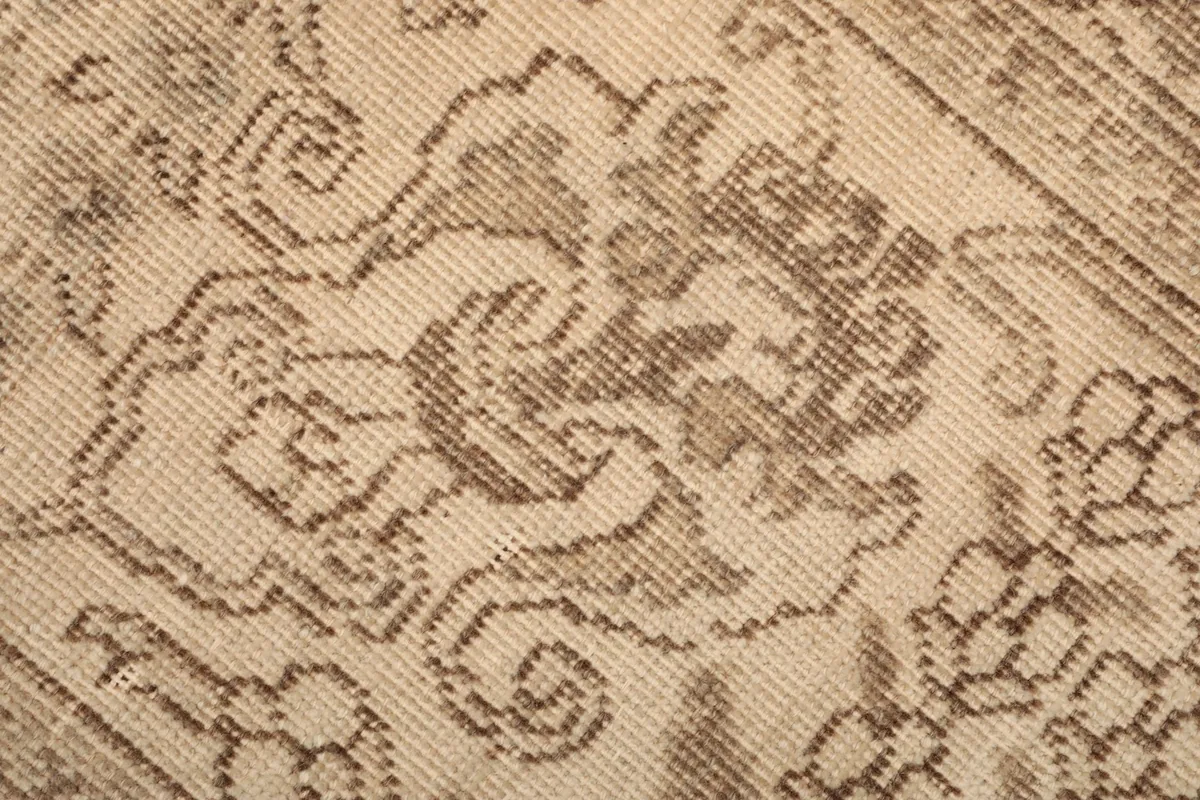 Macro shot of the rug's low wool pile and hand-knotted texture