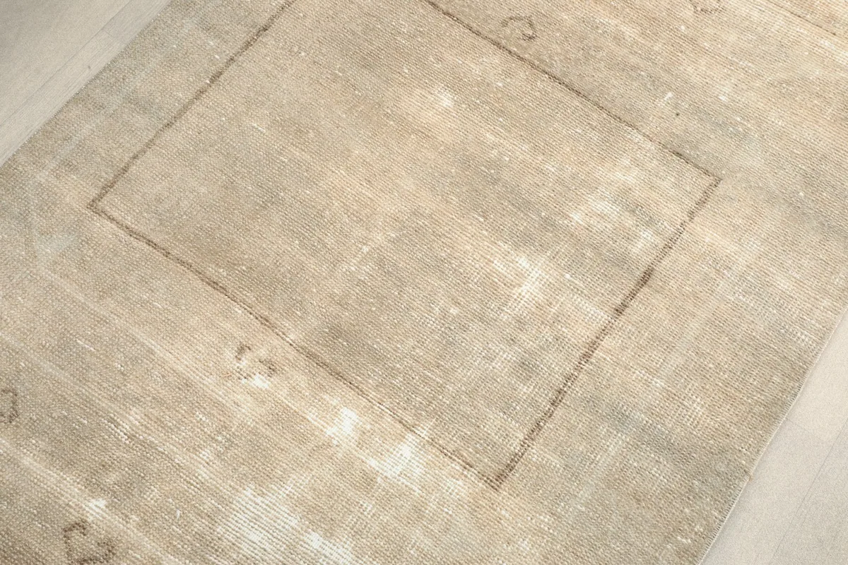 Detailed view of the rug's texture and the subtle brown geometric lines