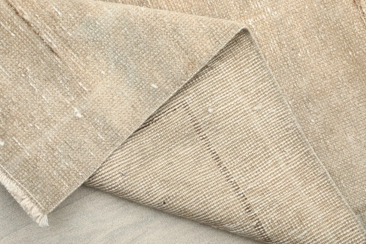 Underside of the runner rug, showing the hand-knotted cotton foundation