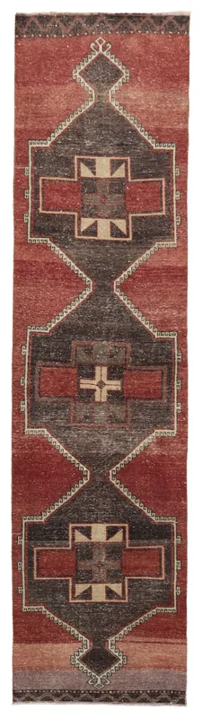 Full overhead view of the hand-knotted red and charcoal vintage Anatolian runner rug on a white background