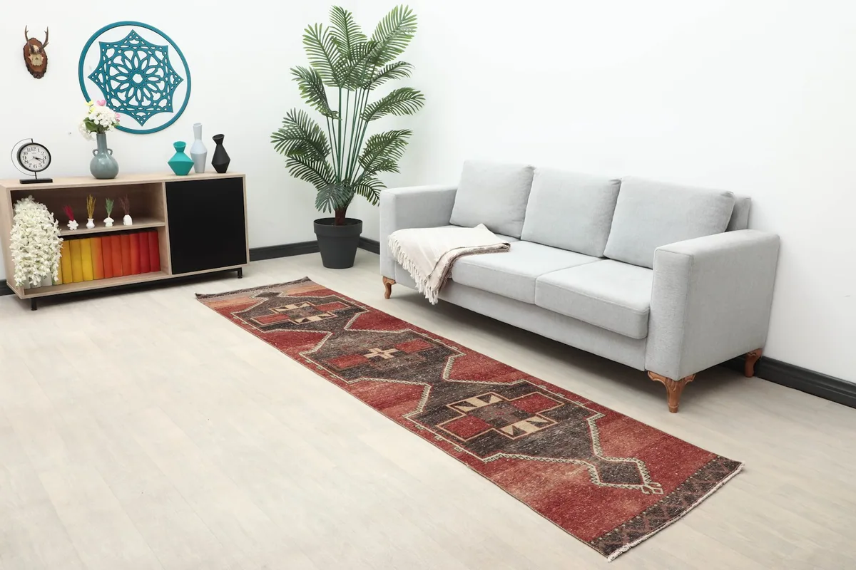 Long view of the red and charcoal geometric runner rug extending through a hallway or living area
