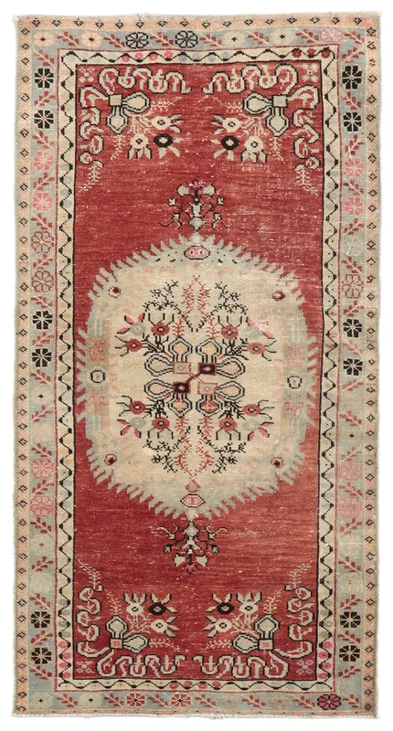 Full overhead view of the red and ivory vintage Anatolian rug on a white background.