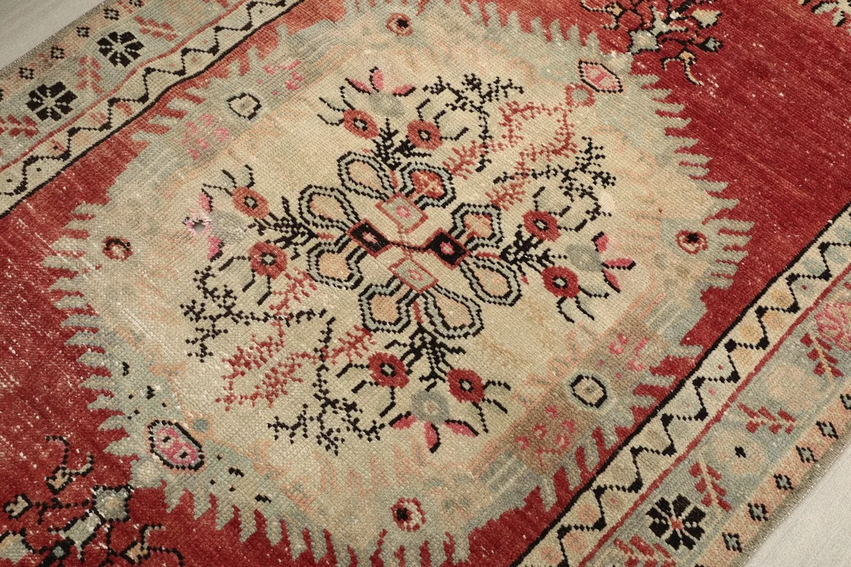 Close-up of the central ivory medallion with its delicate floral and geometric motifs.