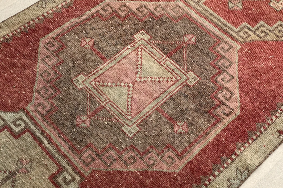 Close-up of a central medallion with intricate tribal geometric designs and color variations.