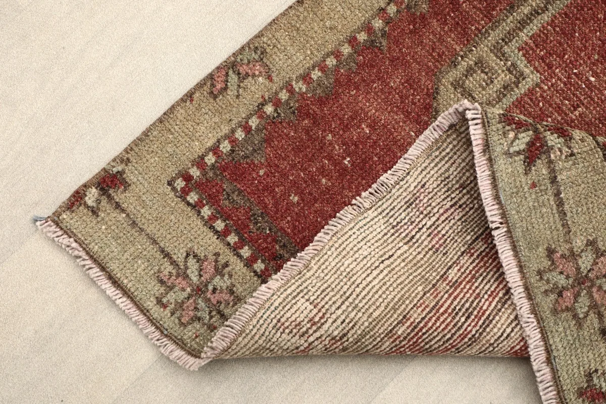 Corner of the runner folded to show the wool pile on cotton foundation and fringe.