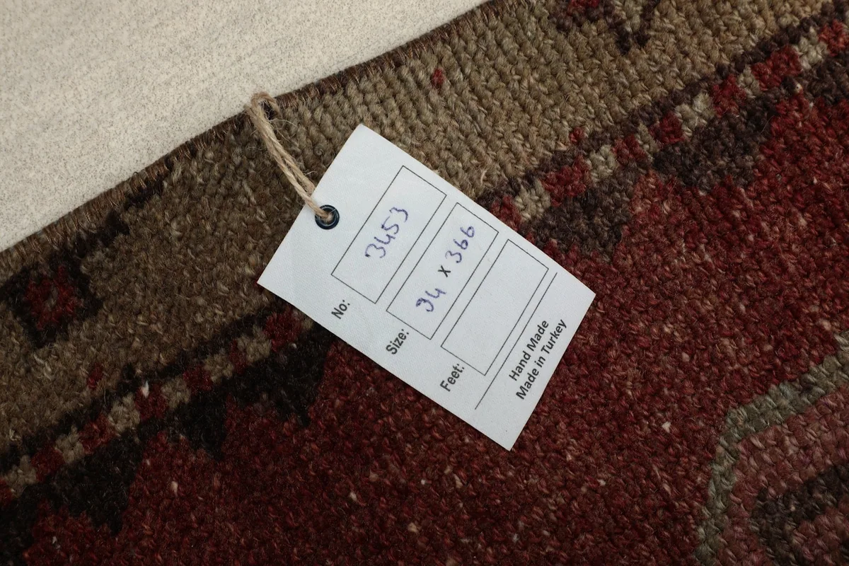 Close-up of the rug's label, indicating hand-made in Turkey and dimensions.