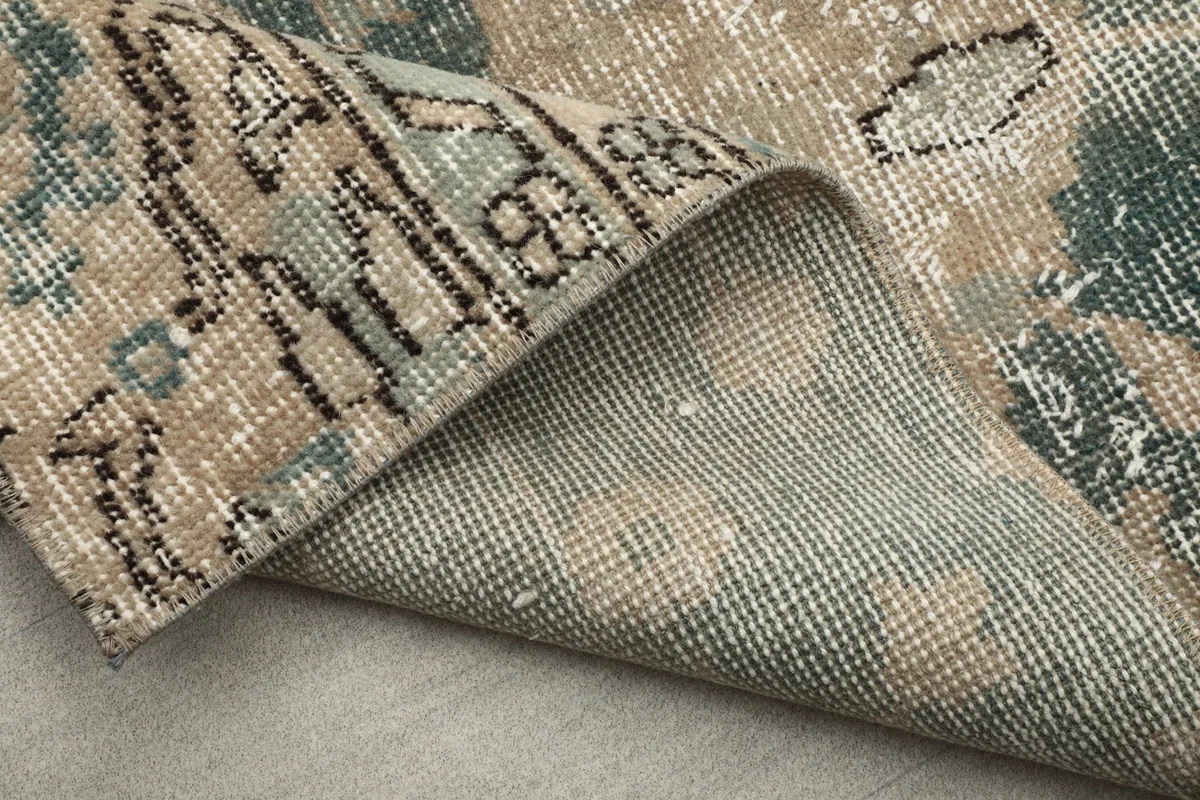 Another view of the rug's cotton foundation and the reverse side of the hand-knotted pile