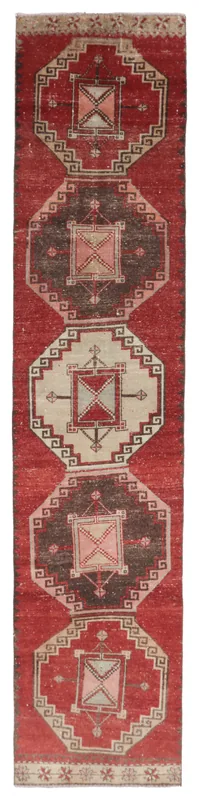 Full overhead view of the vintage Anatolian runner rug on a white background