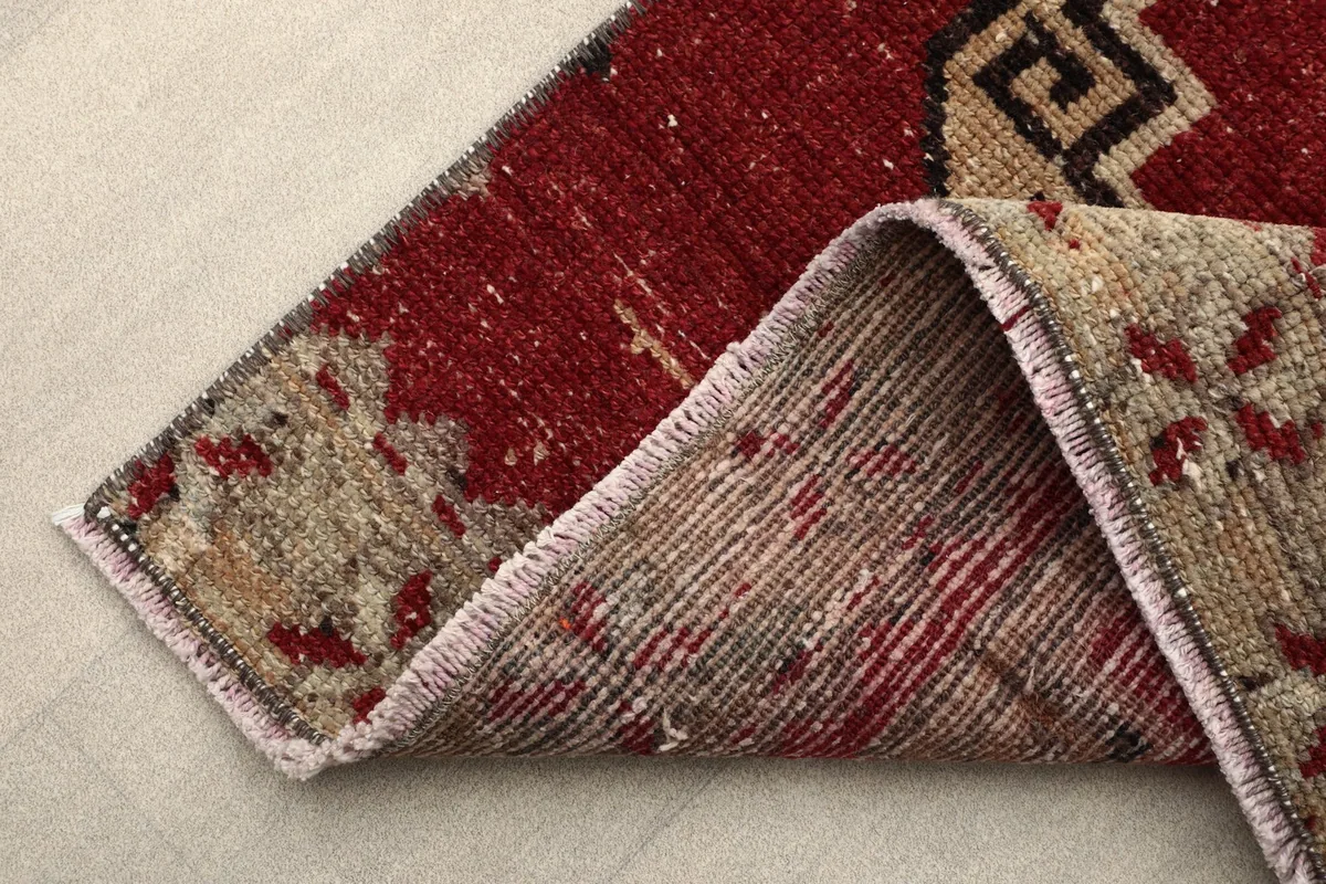 Folded corner of the rug, illustrating the thickness of the low pile and the construction