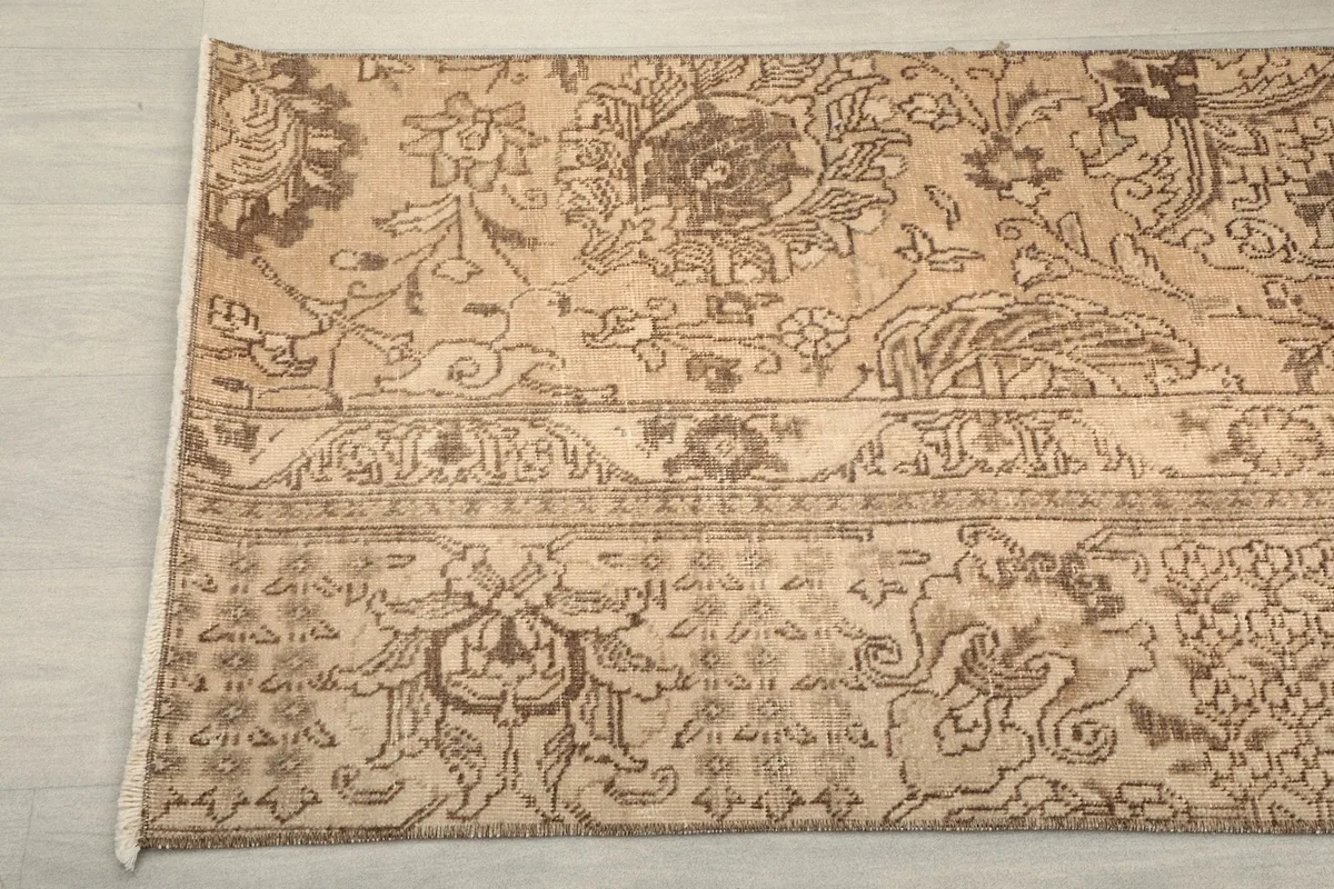 Close-up of the rug's border and field, showcasing the intricate floral and tribal designs.