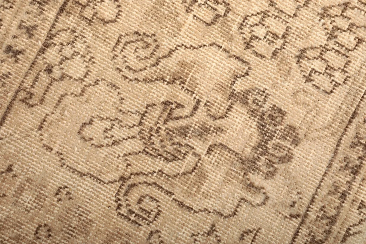 Macro view of the hand-knotted wool pile, showing the detailed weave and color variations.