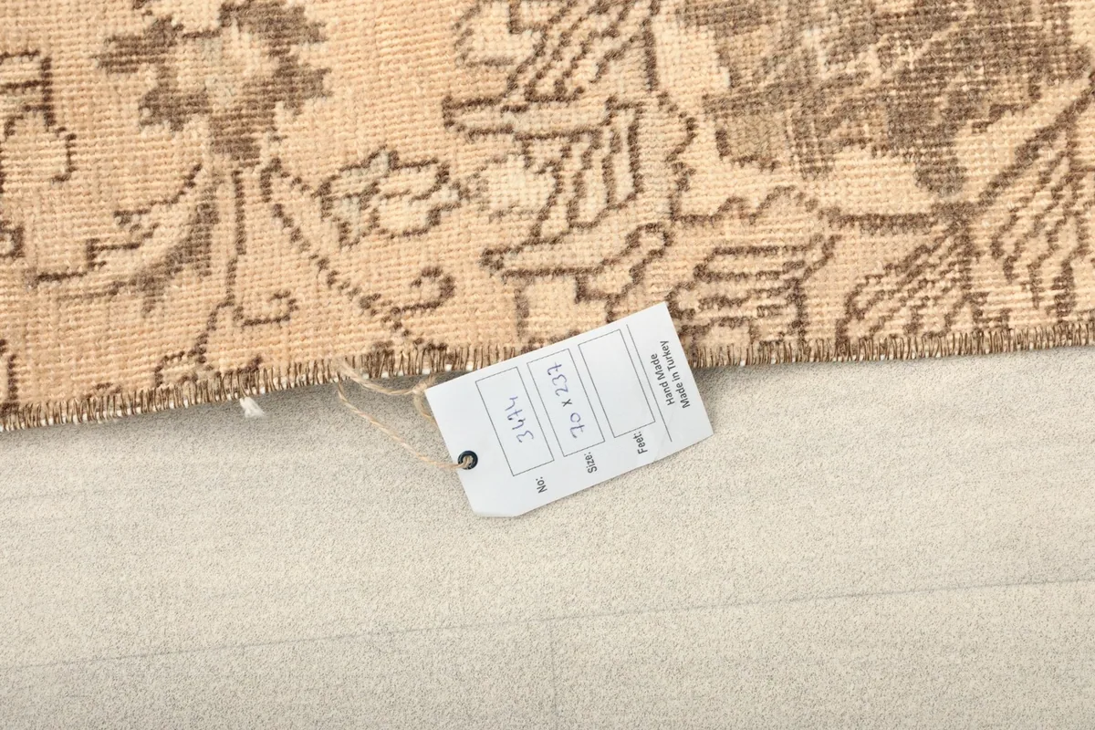 Close-up of the rug's corner with a product tag, indicating its origin and material.