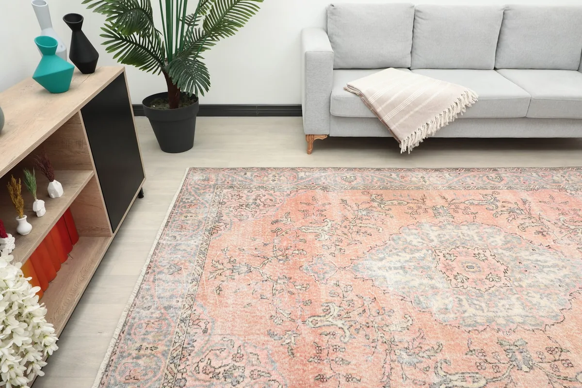 Overhead angle of the rug in a room, highlighting its placement next to a sofa and cabinet