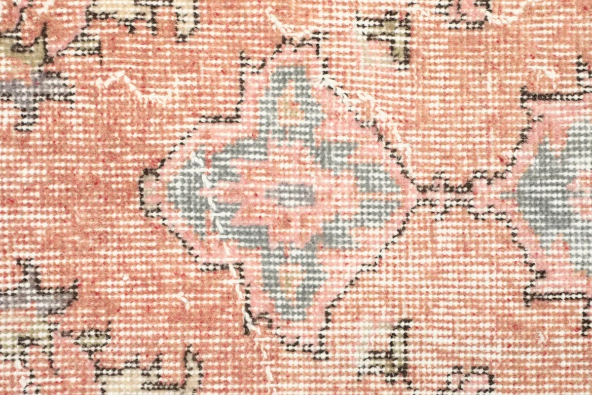 Texture and low pile of the vintage wool rug, showing subtle wear and color variations