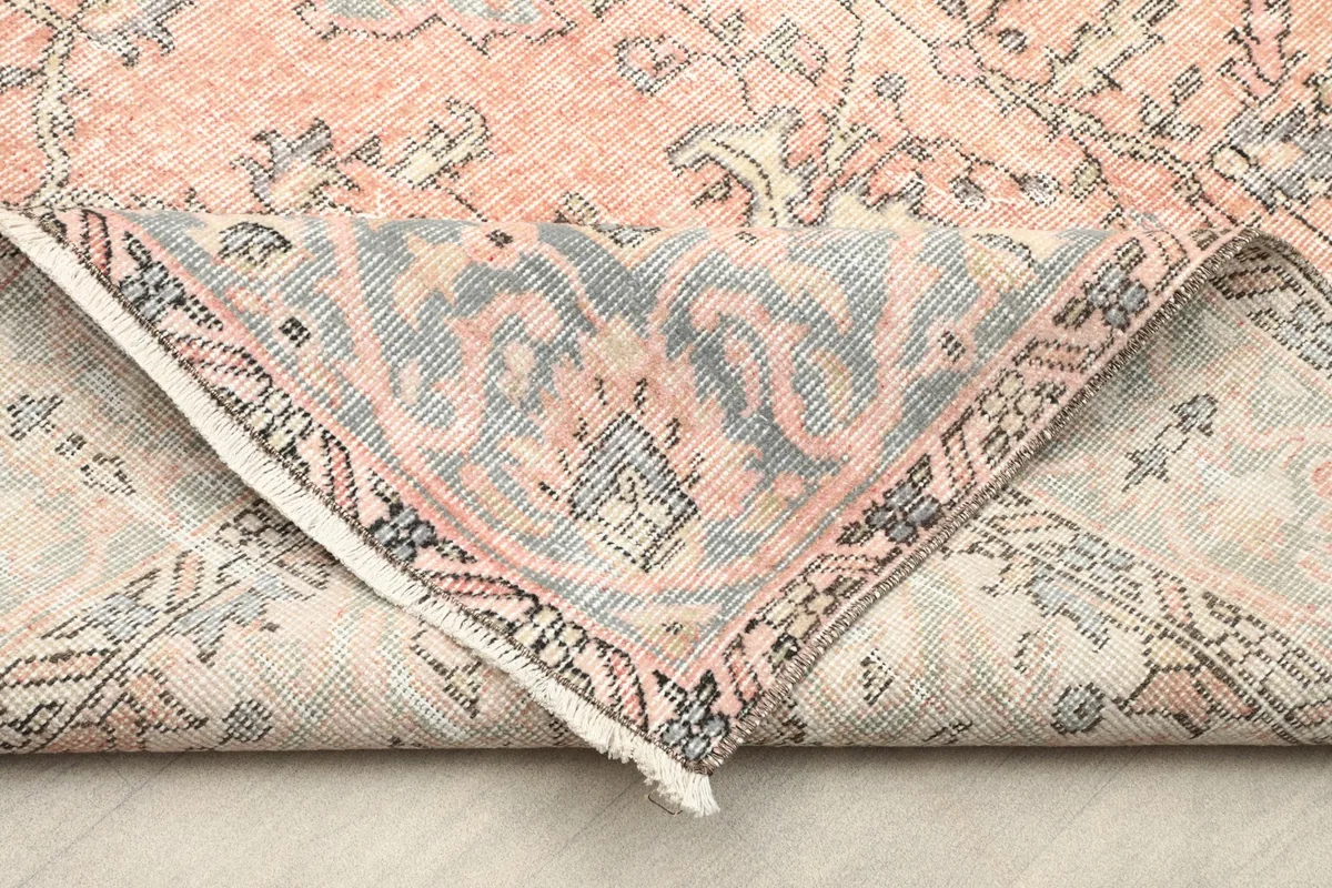 Underside view of the hand-knotted wool rug, revealing its cotton foundation and craftsmanship