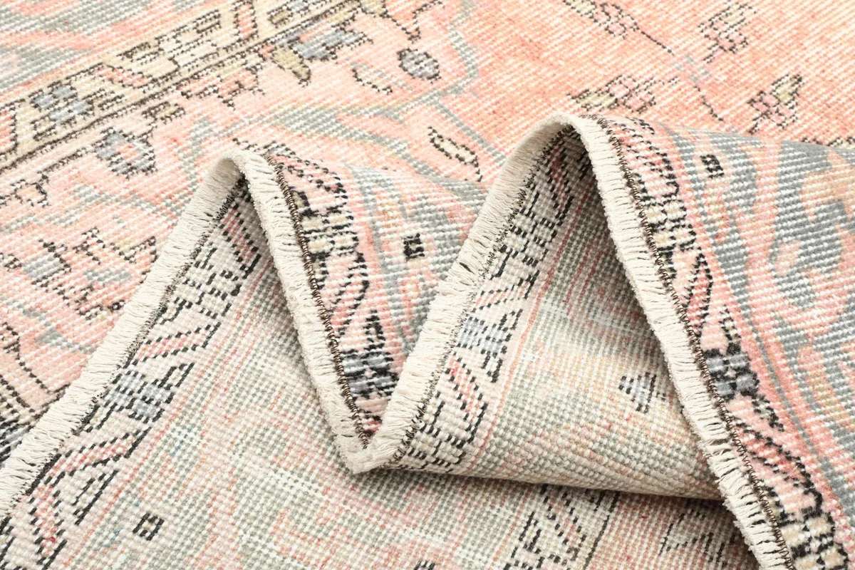 Folded section of the rug, showing the flexibility and density of the hand-knotted wool