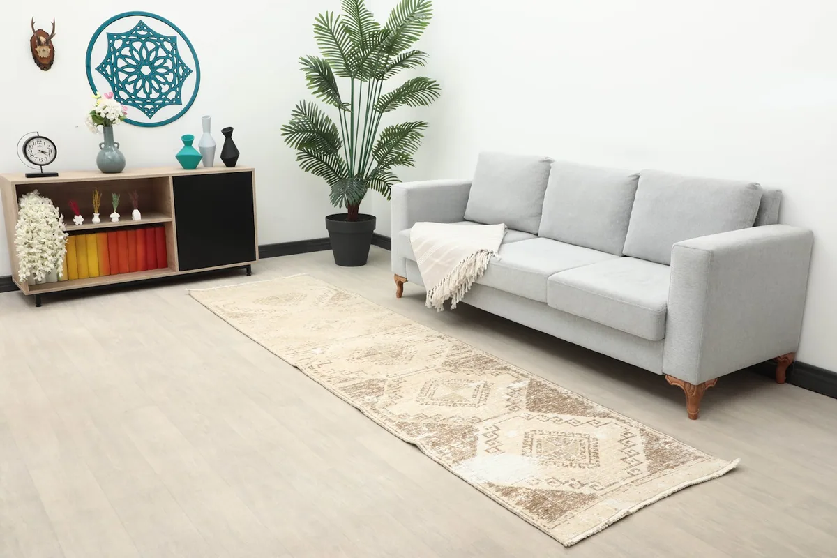 Long view of the Anatolian runner in a living space with a sofa and side cabinet