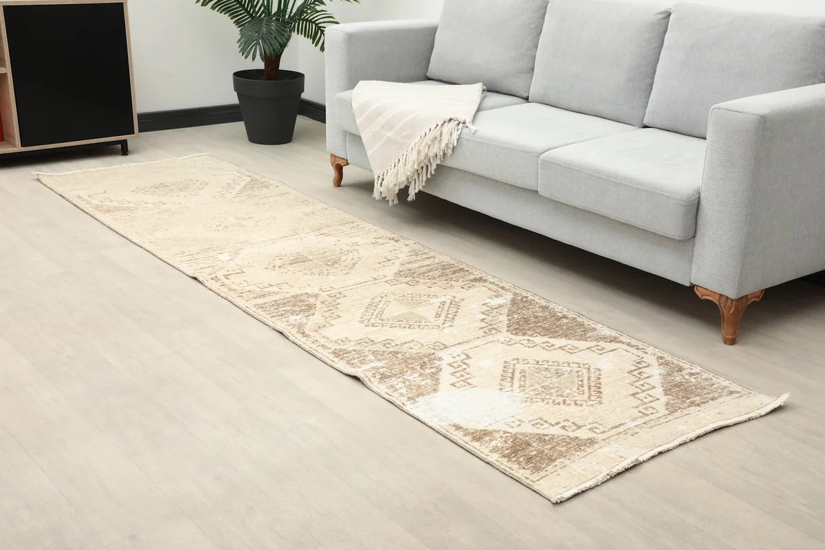 Angled view of the beige runner showing its length in a modern room setting