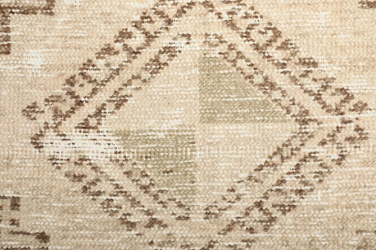 Macro detail of the hand-knotted wool pile and intricate tribal patterns