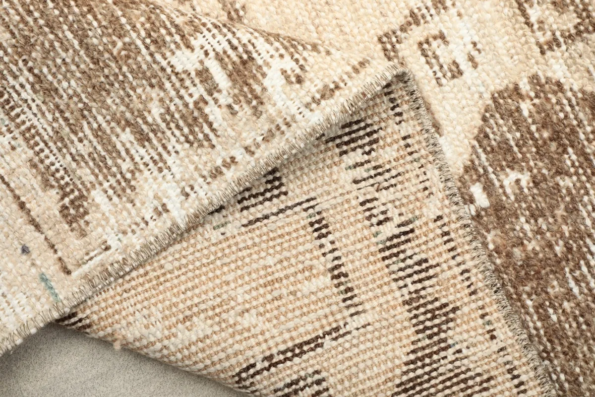 Detailed view of the back of the hand-knotted rug, revealing the cotton foundation