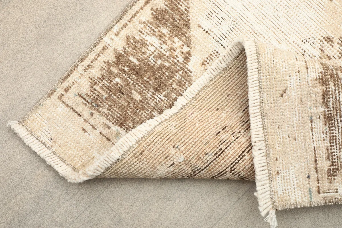 View of the runner folded to show the wool pile texture and cotton foundation
