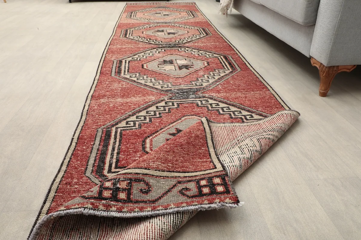 Partially folded rug showing the pile and the reverse side, demonstrating its flexibility and construction.